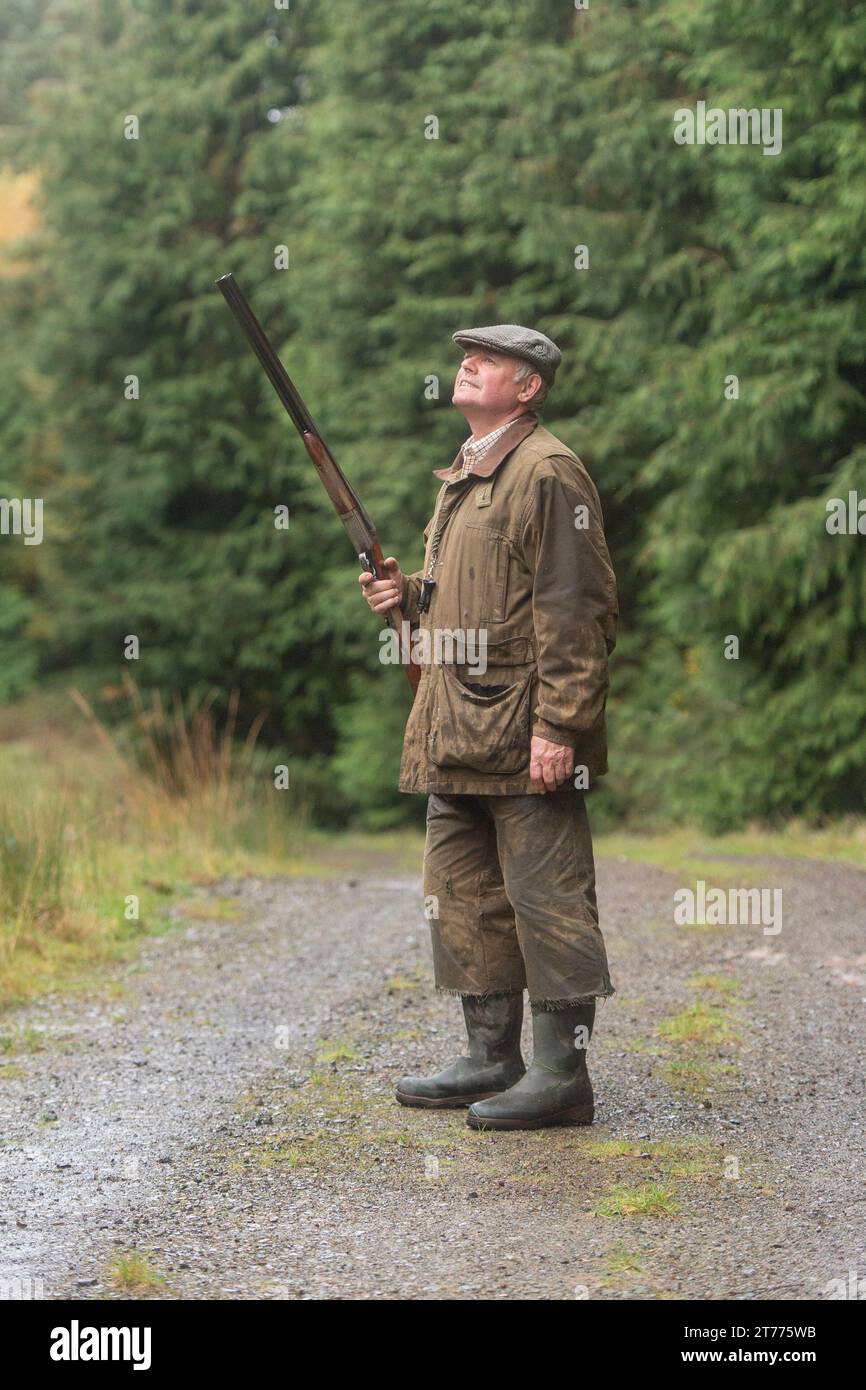 man shooting brds in the forest Stock Photo