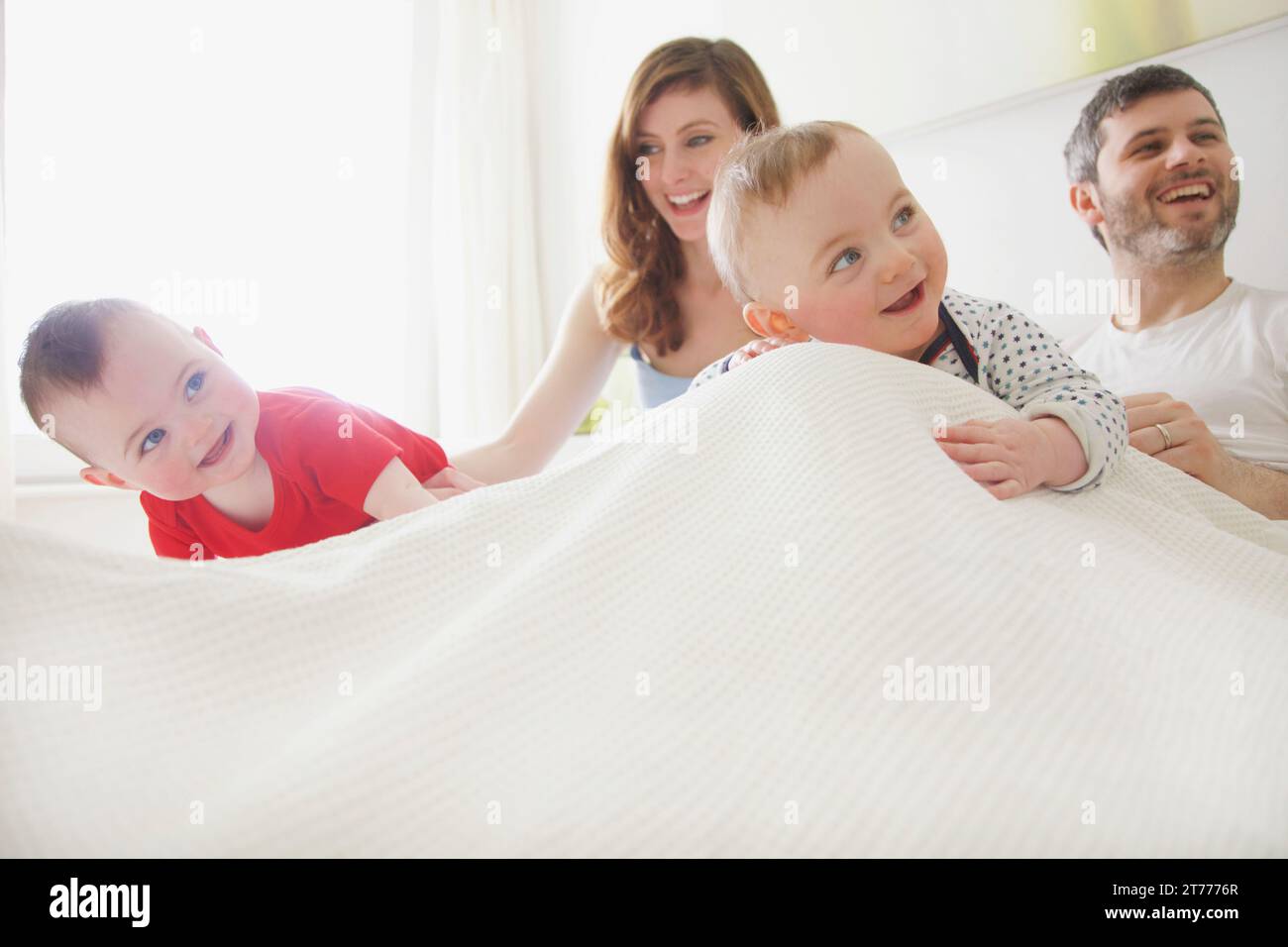 Couple in Bed with Baby Twins Stock Photo Alamy