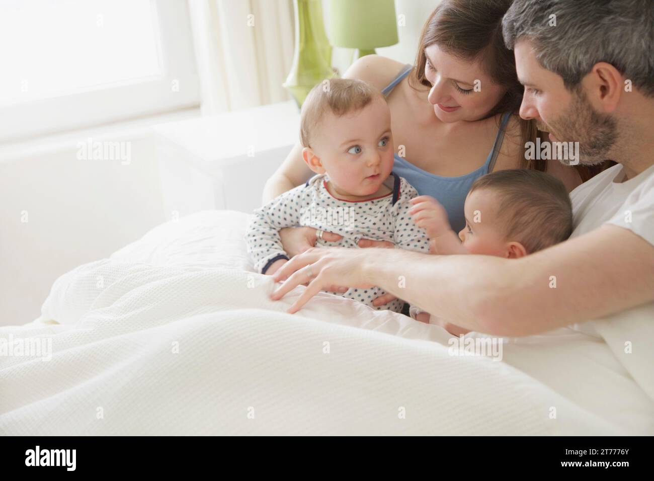 Couple in Bed with Baby Twins Stock Photo Alamy