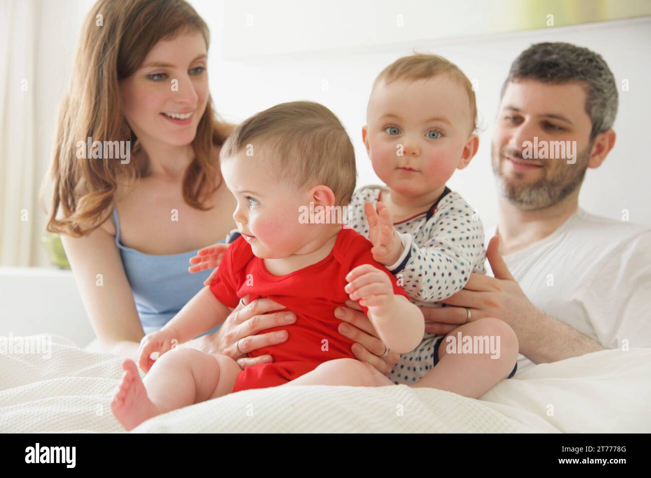 Couple in Bed with Baby Twins Stock Photo Alamy