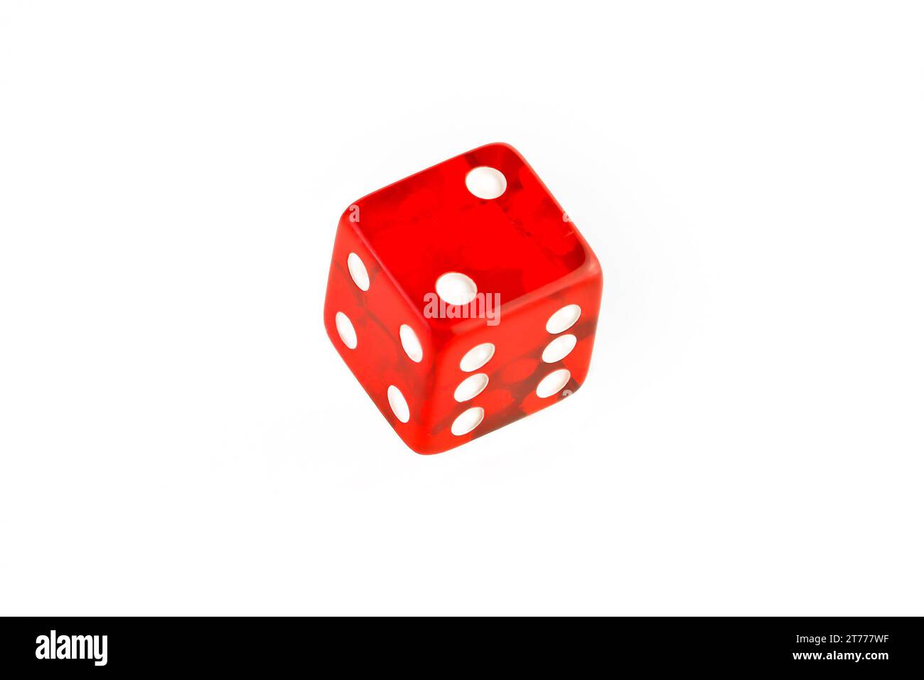 one transparent red die on a white background Stock Photo
