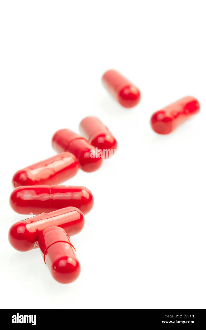 close-up of red medical pills on white background Stock Photo