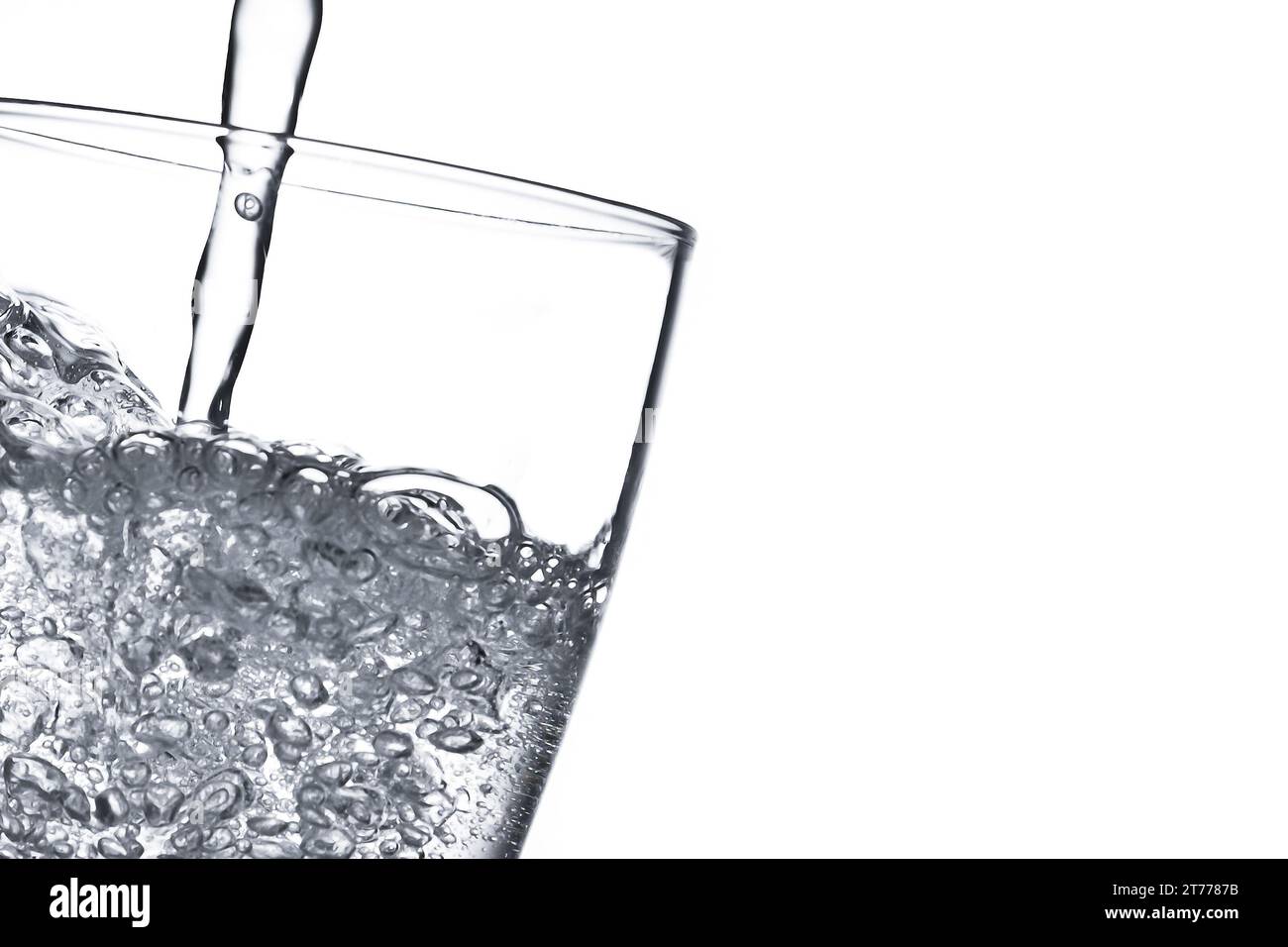 pouring water from glass on white background with space for text Stock ...