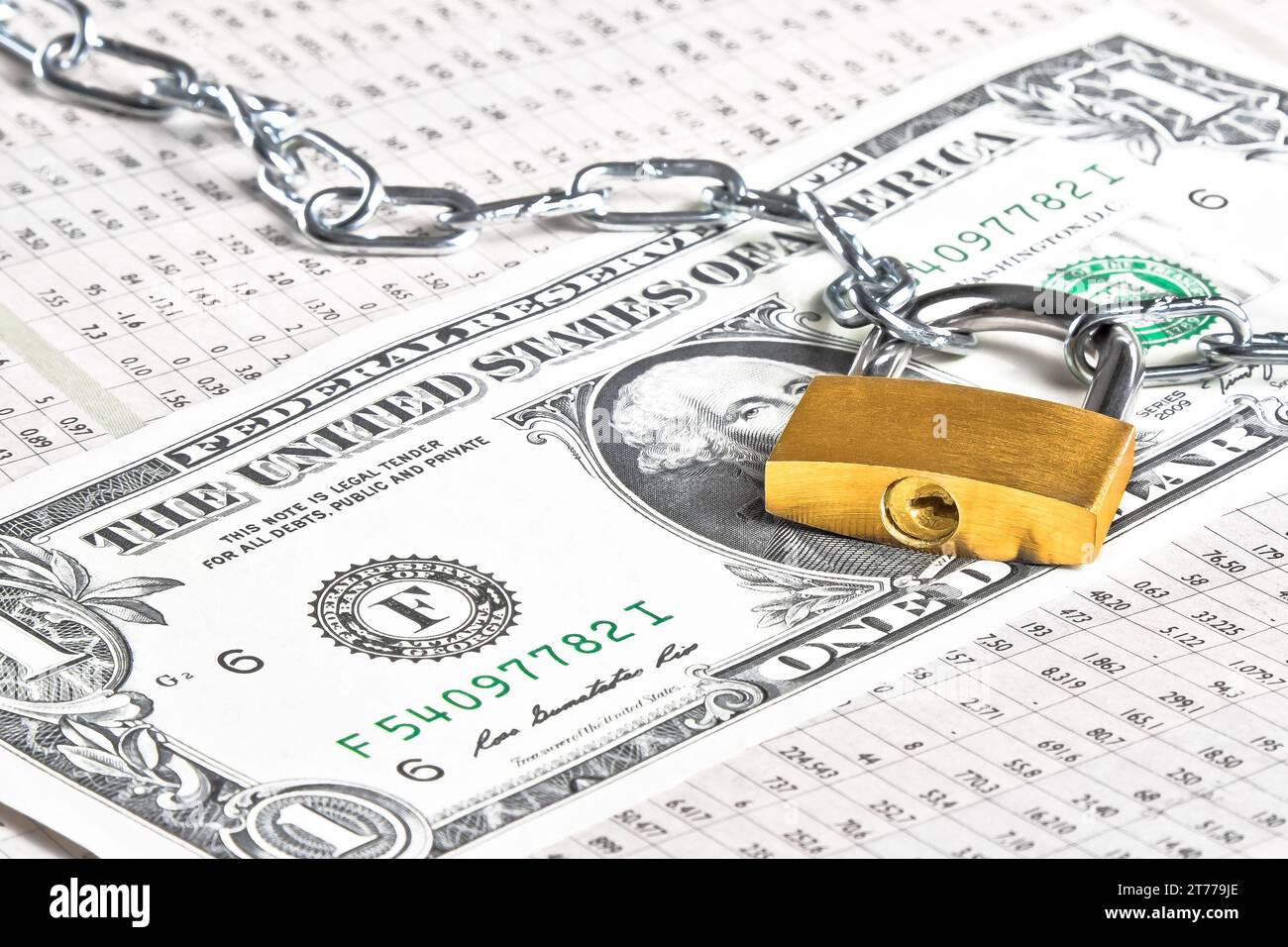 dollar banknote with lock security and chain on financial newspaper. Money for safety and investment. Stock Photo