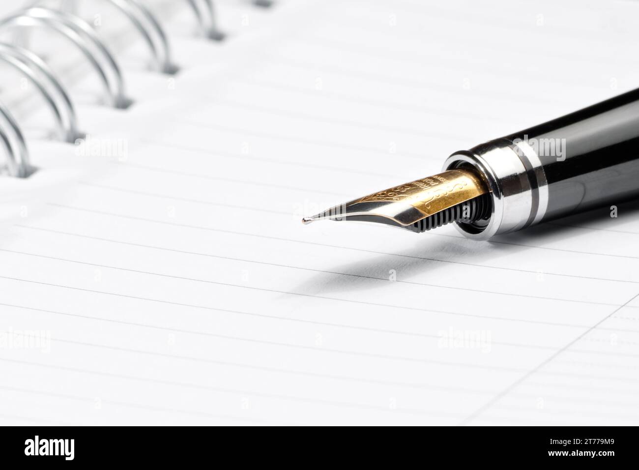 golden fountain pen in composition on notebook Stock Photo Alamy