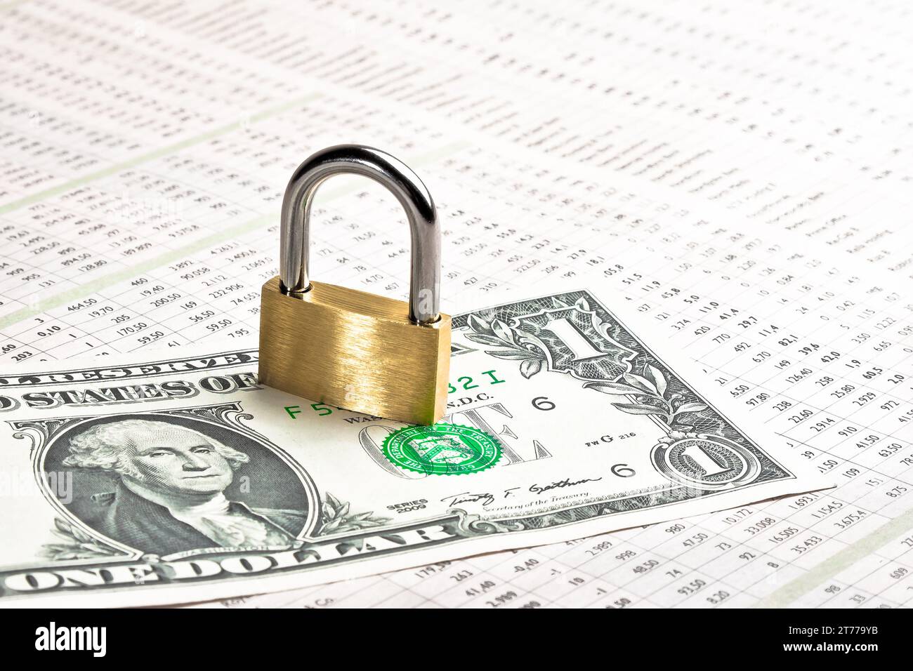 dollar banknote with lock on financial newspaper. Money for safety and investment. Stock Photo