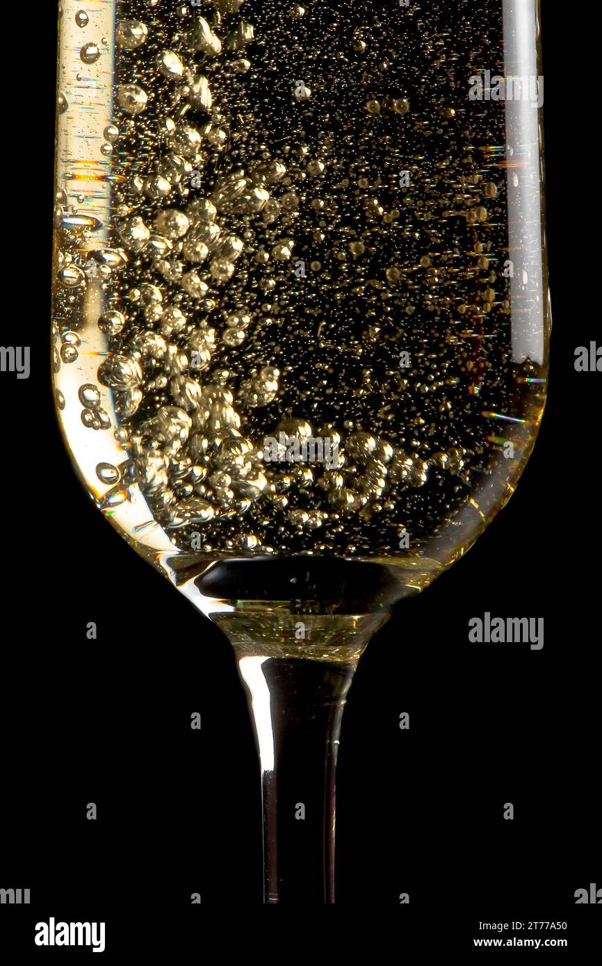 flute of champagne with golden bubbles on black background Stock Photo