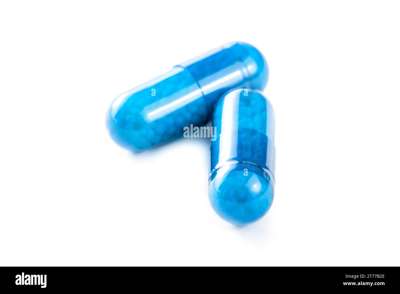 closeup of blue pills on white background Stock Photo