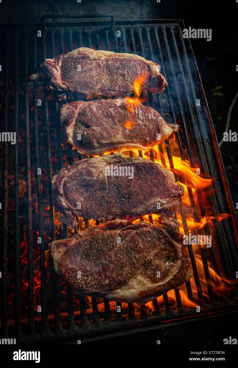 Wagyu entrecote beef steaks are generously covered in seasoning. Flame ... Wagyu entrecote beef steaks are generously covered in seasoning. Flame ...