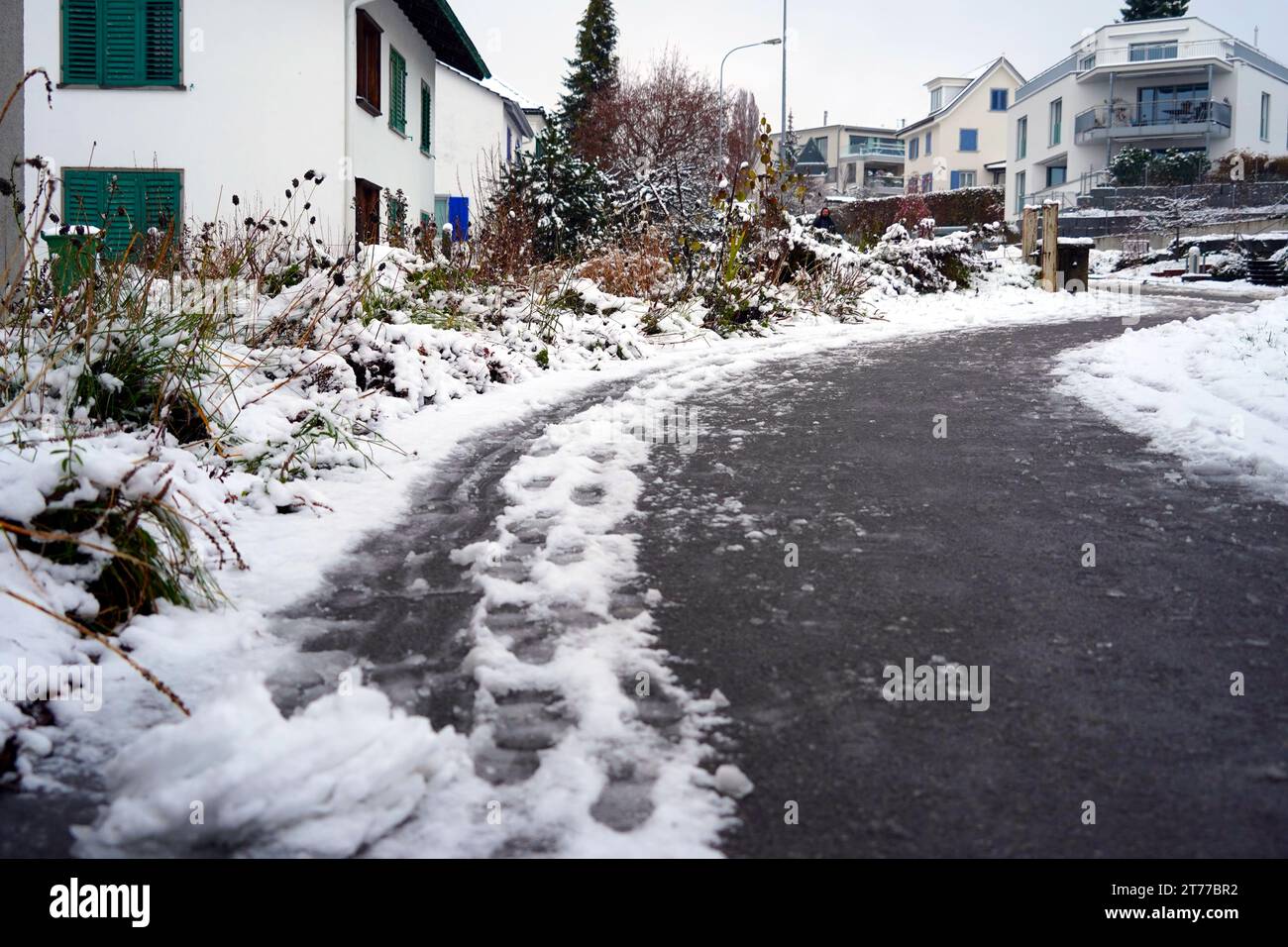 Road and sidewalk in street of Urdorf in Switzerland in winter. Stock Photo