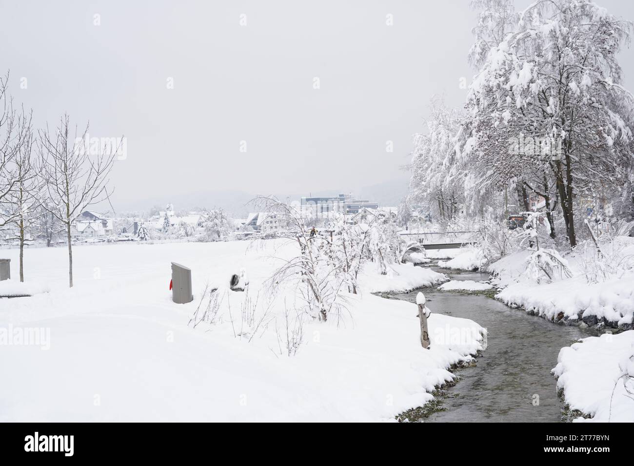 Brook or stream called Schäfflibach in village Urdorf, Switzerland. Captured in winter under extreme snowfall in January 2020. Stock Photo