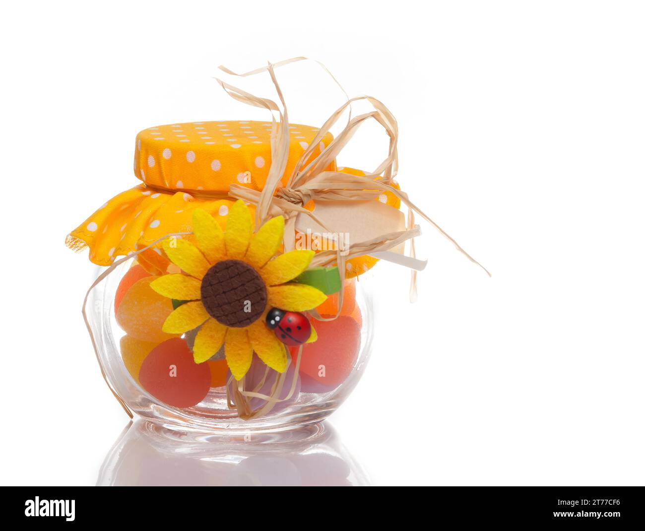 colourful multi coloured candy in a decorative glass jar for a festive gift on white background Stock Photo