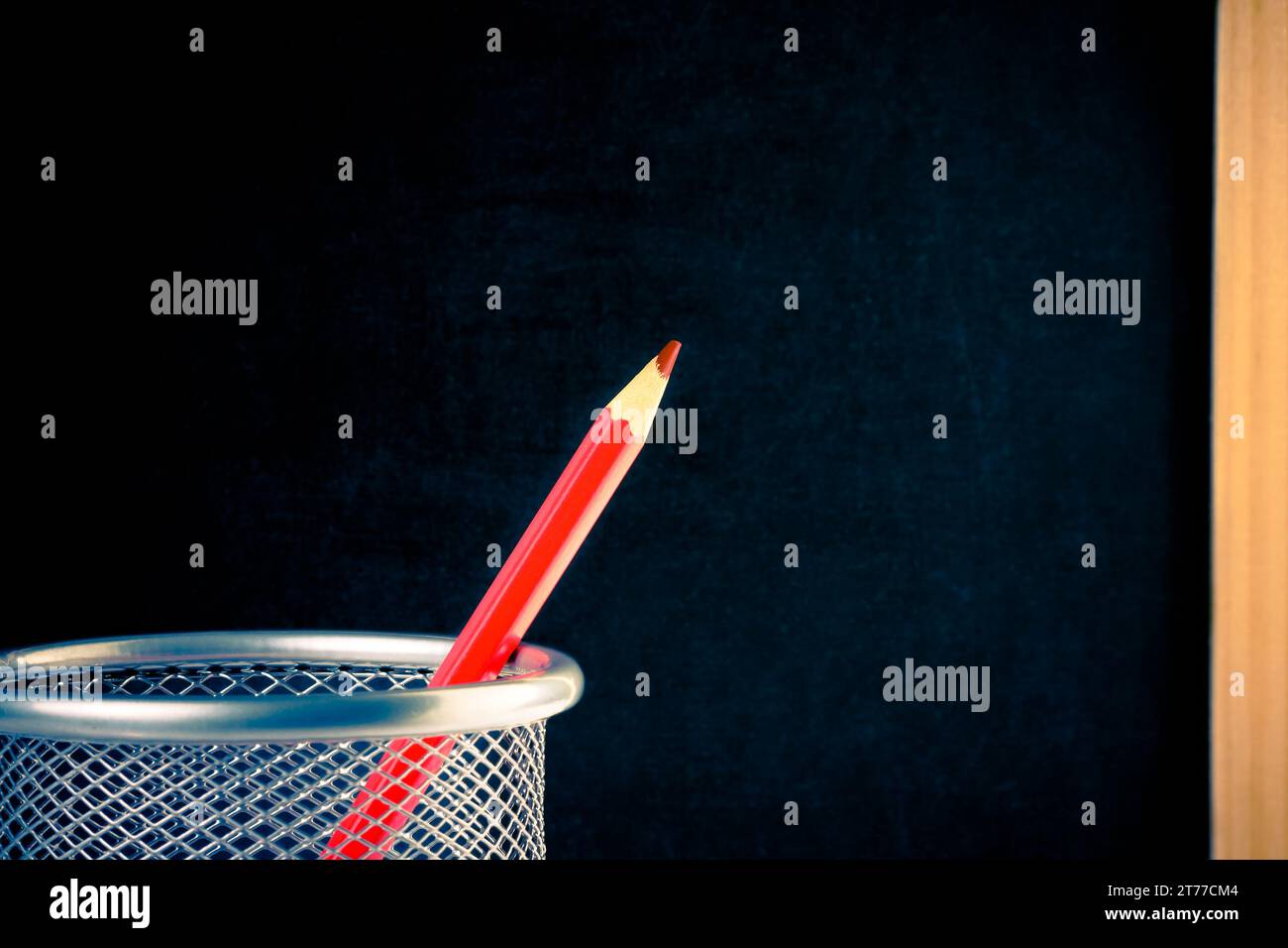 back to school, red pencil in container against empty blackboard for text Stock Photo
