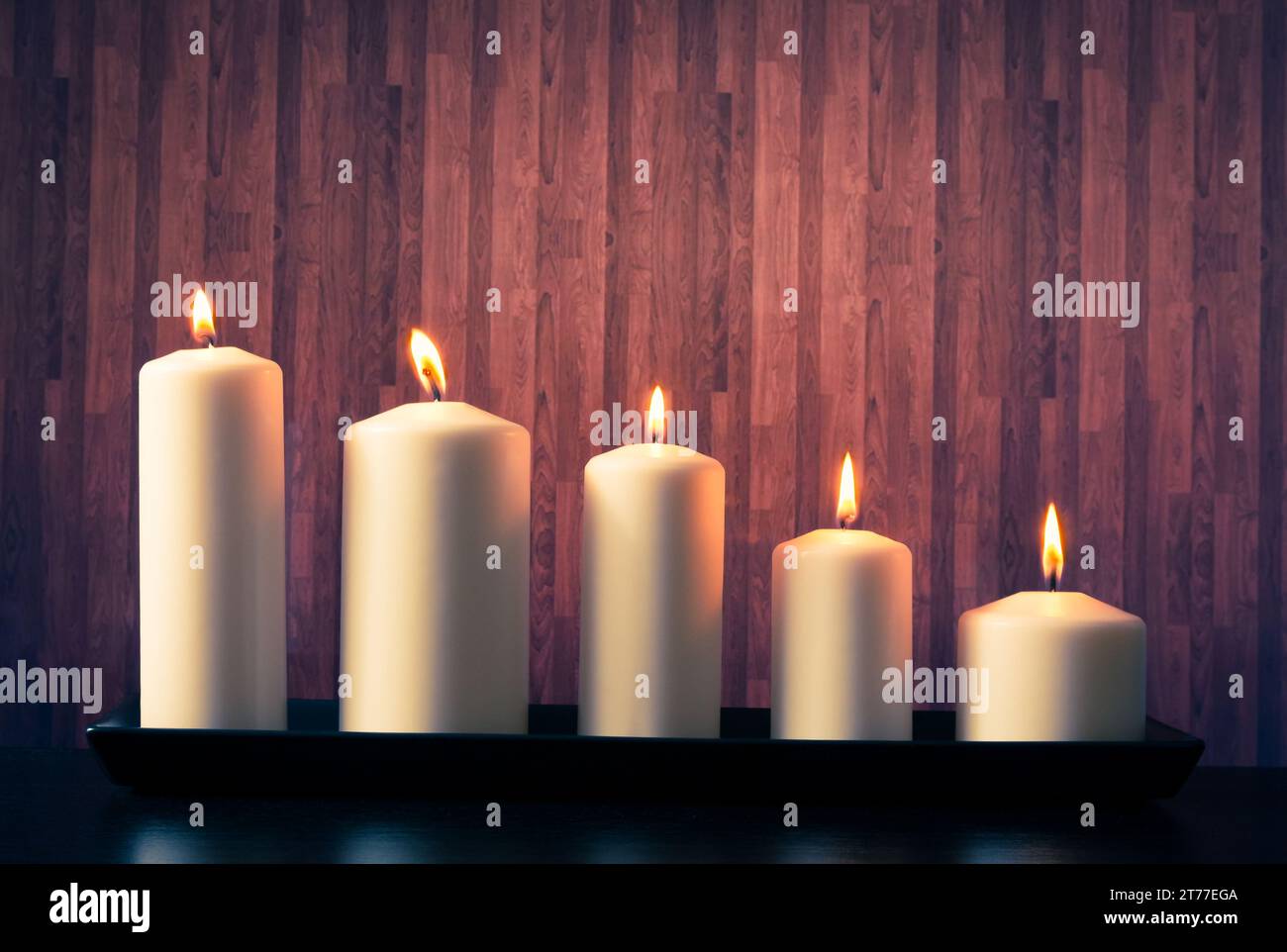 white candles on warm atmosphere and old wooden background Stock Photo