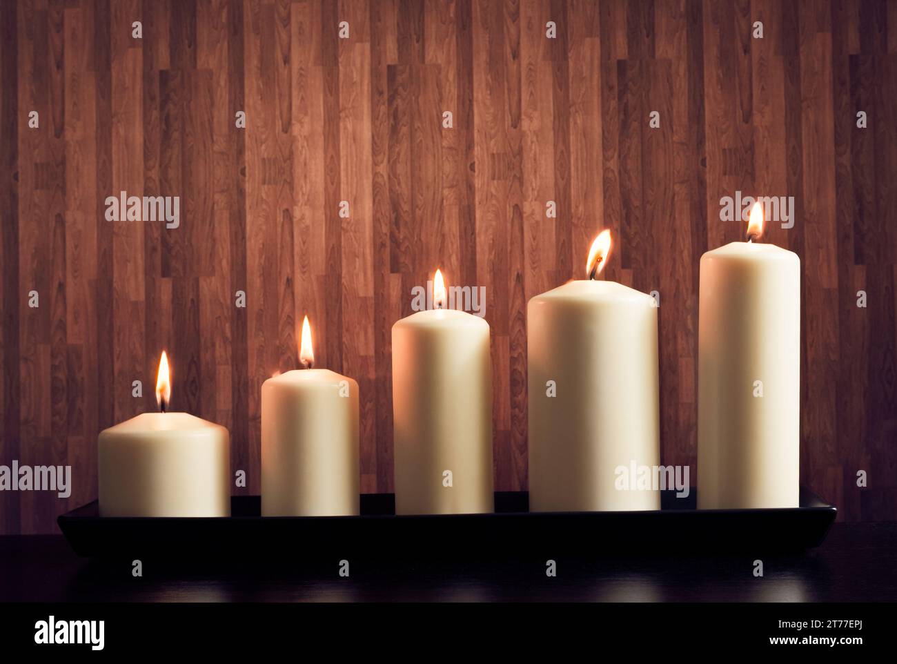 white candles on warm atmosphere and old wooden background Stock Photo