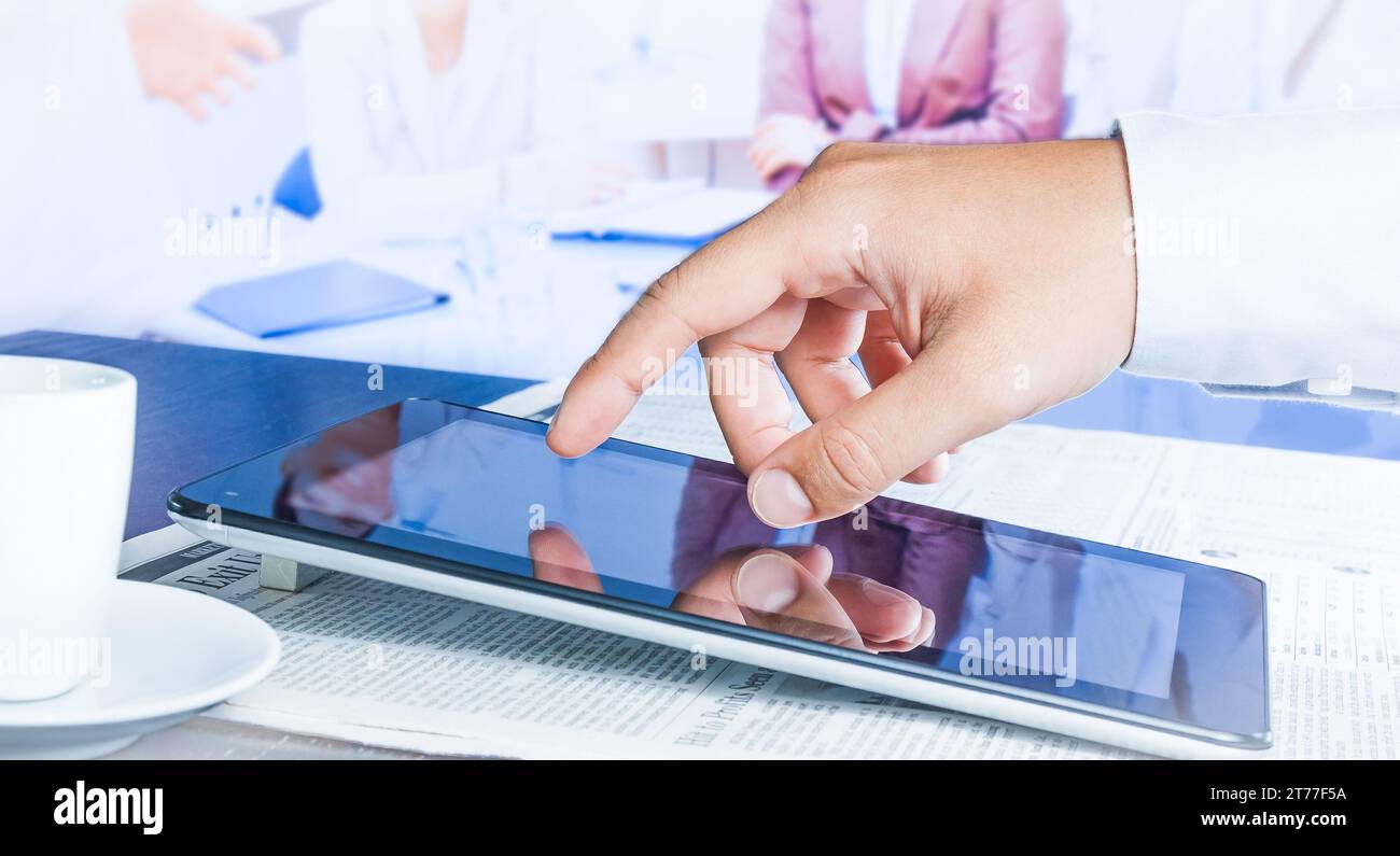 business man touch on a digital tablet in the reunion Stock Photo