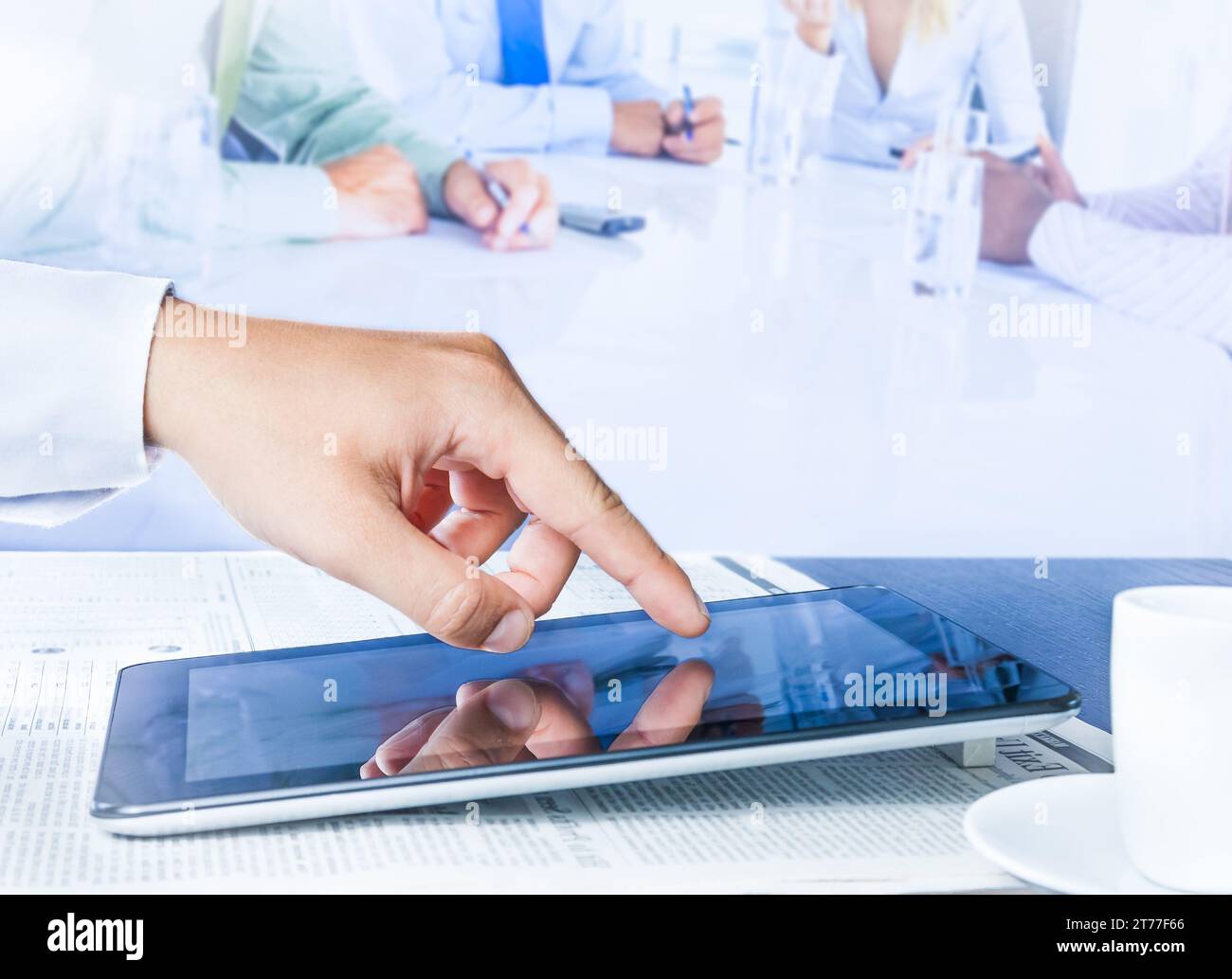 business man working with a digital tablet in the reunion Stock Photo