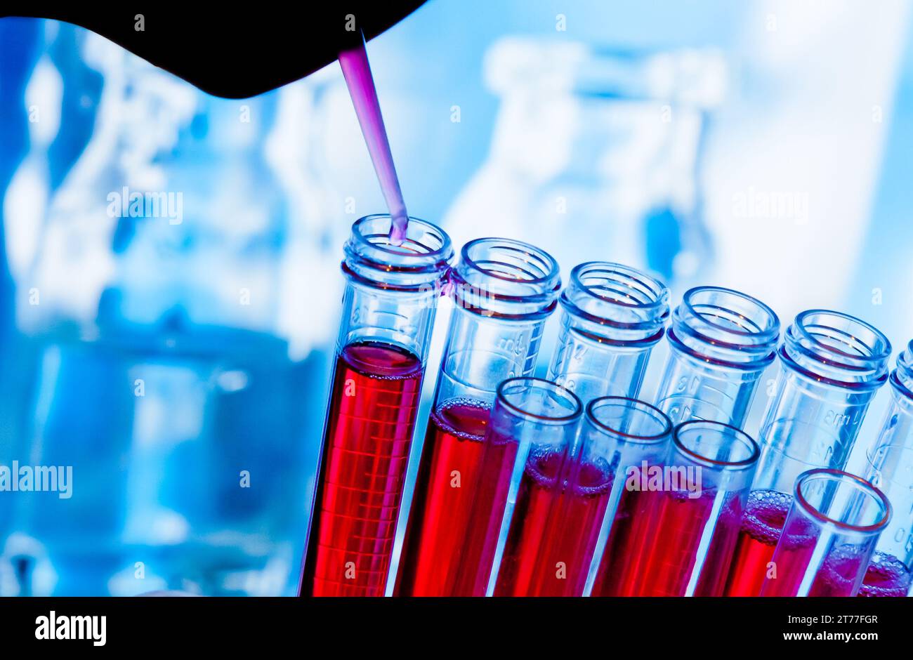 test tubes with pipette on red liquid on blue blur laboratory ...