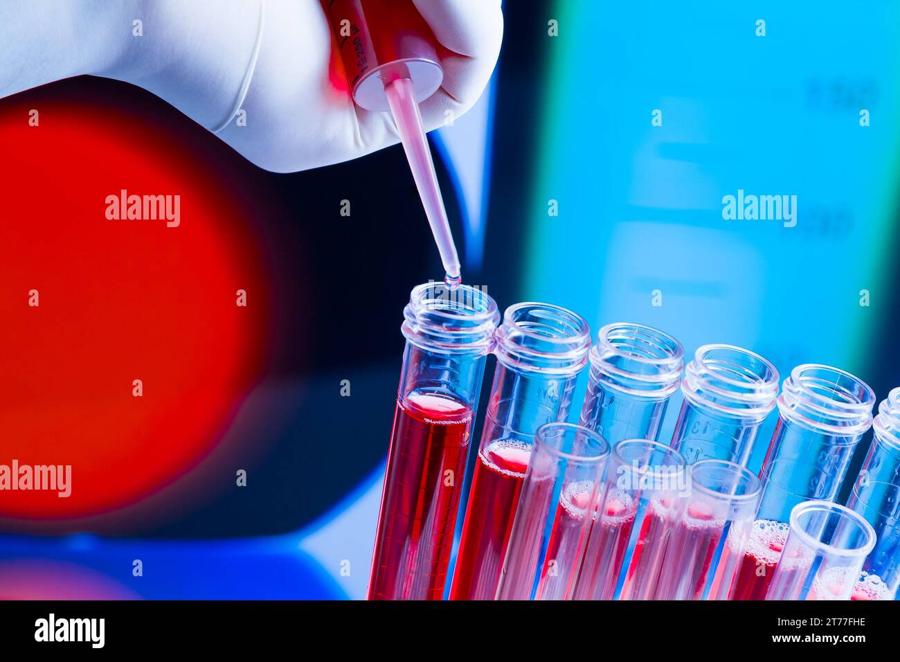 test tubes with pipette on red liquid on blue blur laboratory ...
