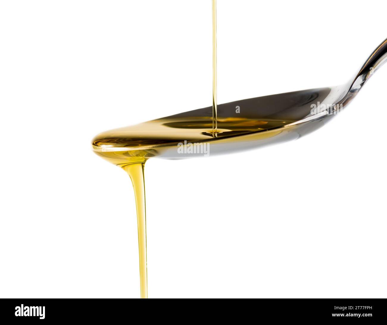 Extra virgin olive oil pouring over a spoon isolated on white background with a space for text Stock Photo
