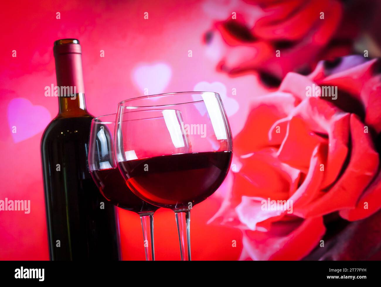 two red wine glasses on blur red roses background, festive and love ...