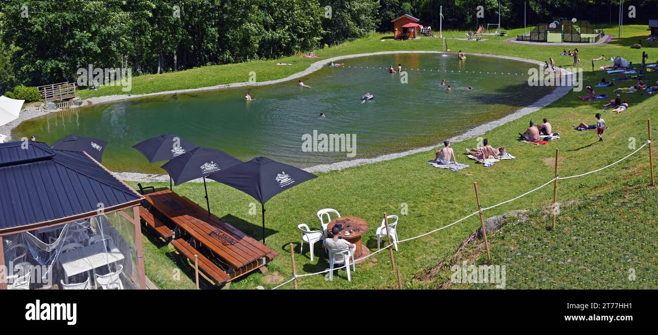 persons at little artificial lake, France, Savoie, Maurienne valley, Saint Colomban des Villards Stock Photo