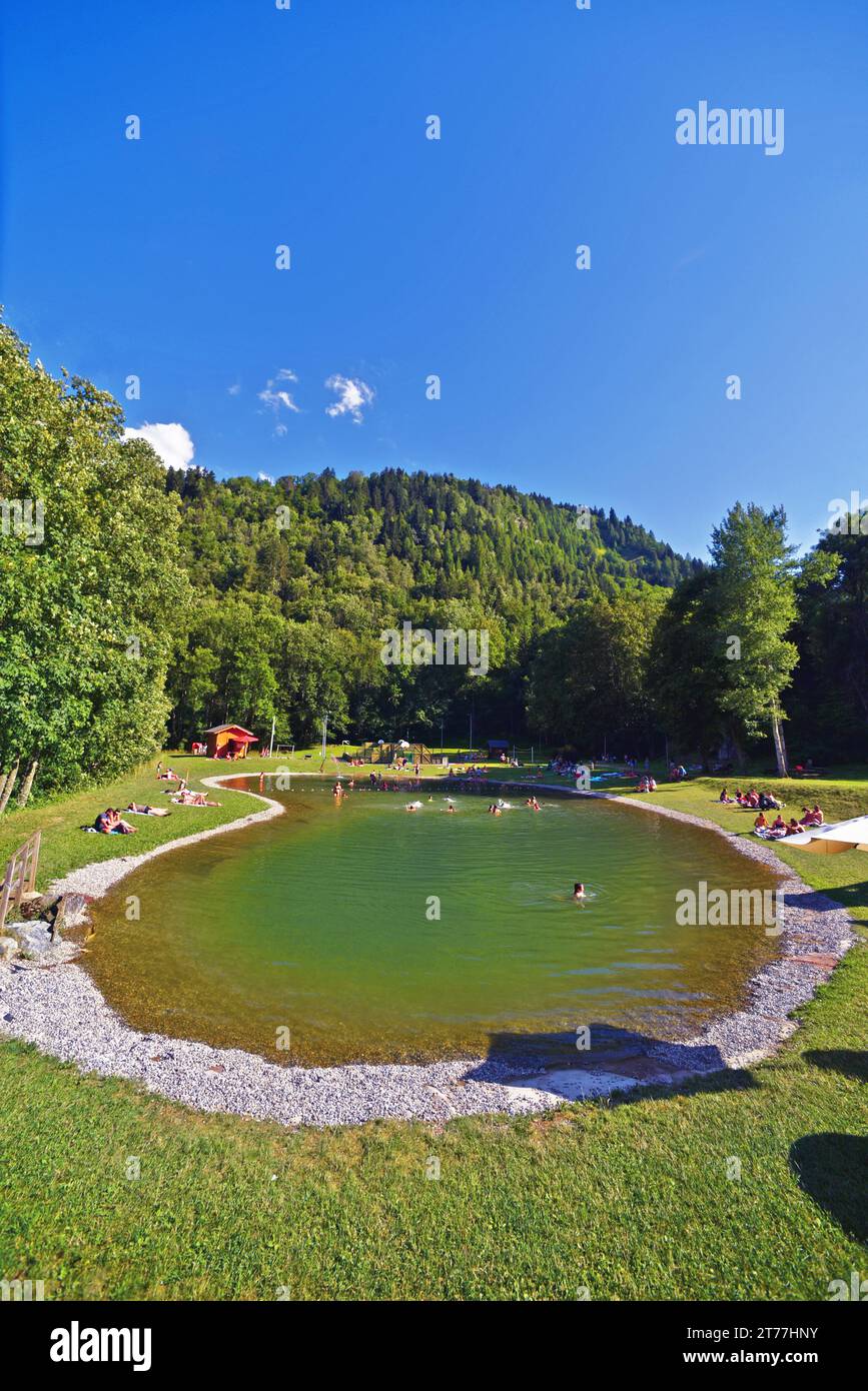 persons at little artificial lake, France, Savoie, Maurienne valley, Saint Colomban des Villards Stock Photo
