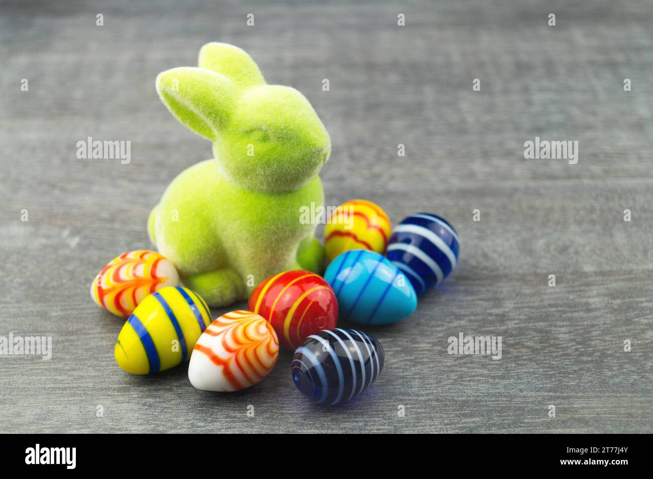 green Easter bunny and Easter eggs on grey underground Stock Photo