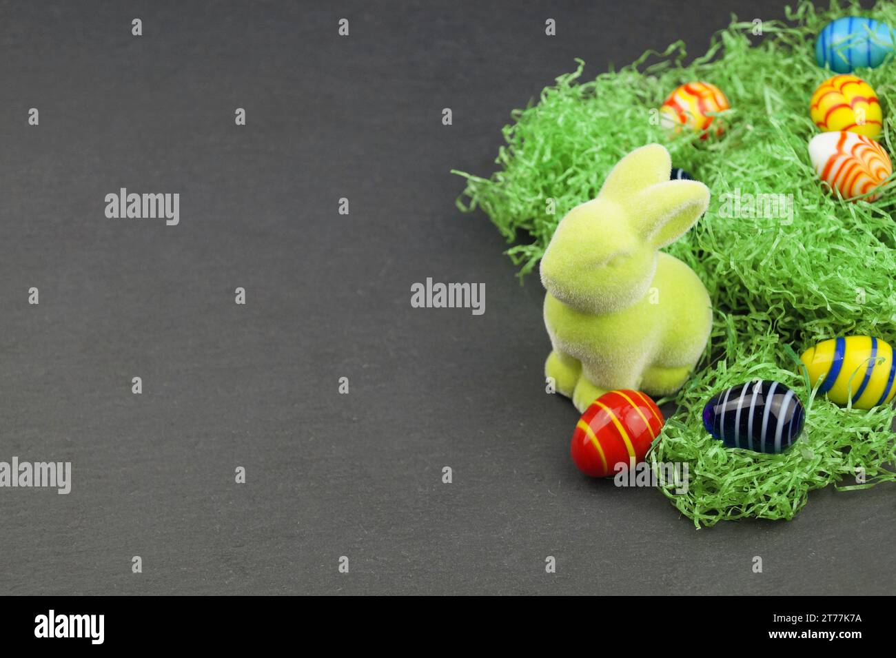 green Easter bunny and Easter eggs on grey underground Stock Photo