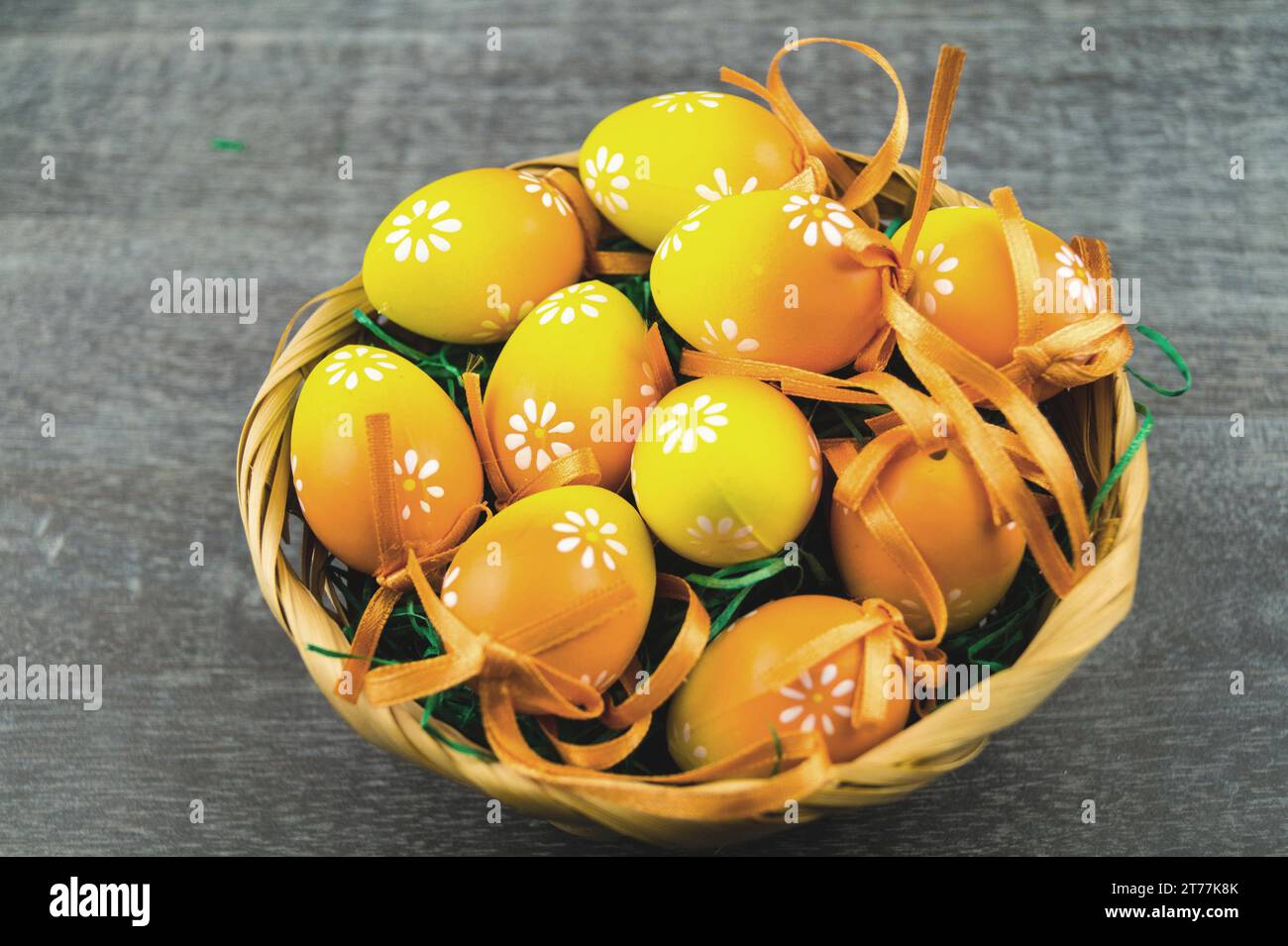 Easter nest with yellow Easter eggs on gray Stock Photo