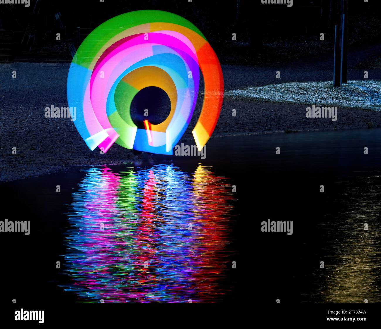 Light painting with multicolored led light stick in darkness Stock Photo