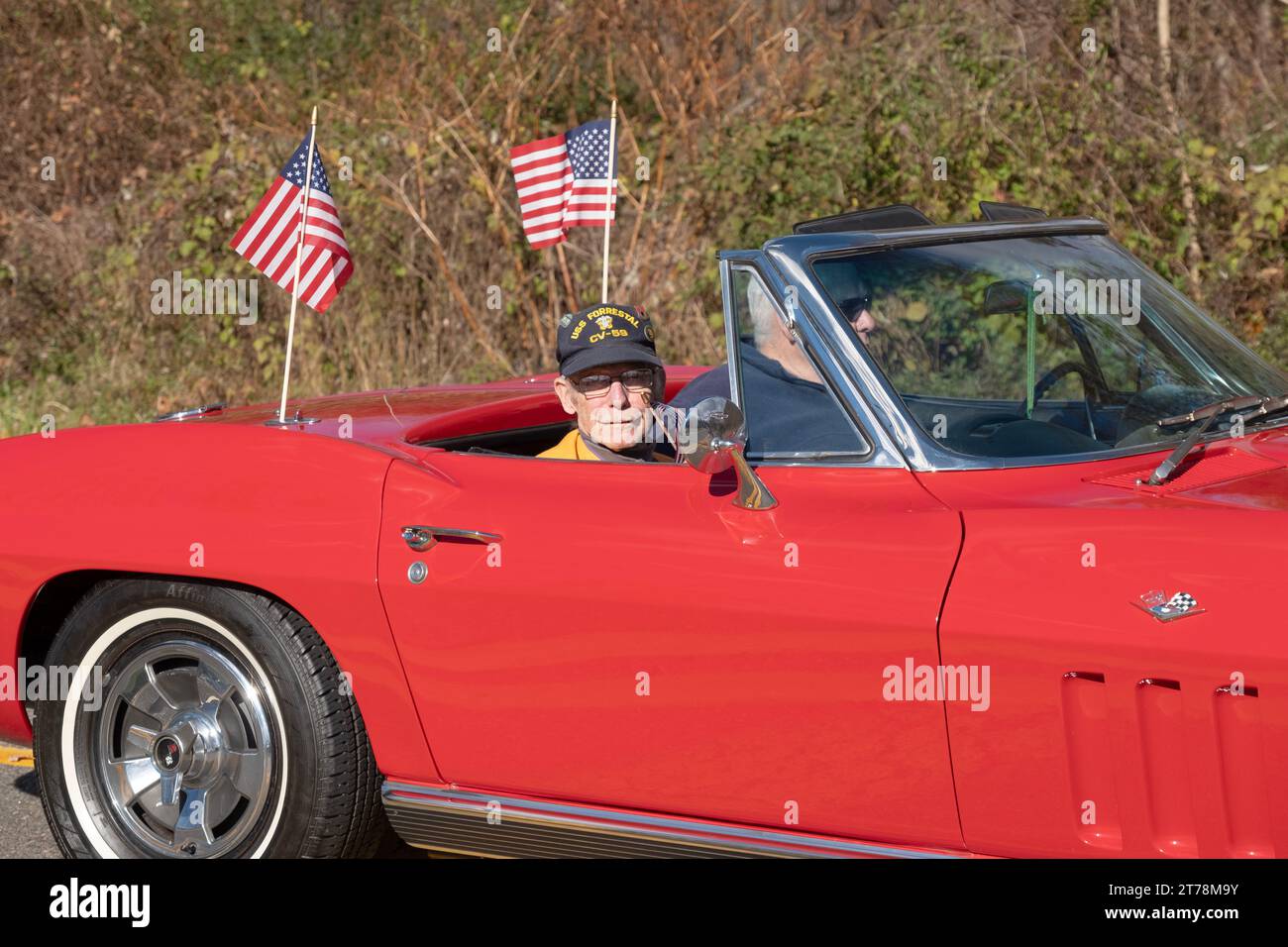 A senior Army veteran rides in one of the lead cars in the annual