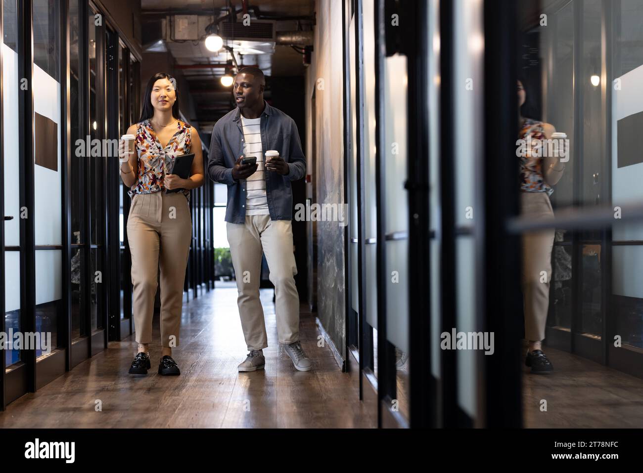 Happy diverse male and female colleagues with tablet and smartphone ...