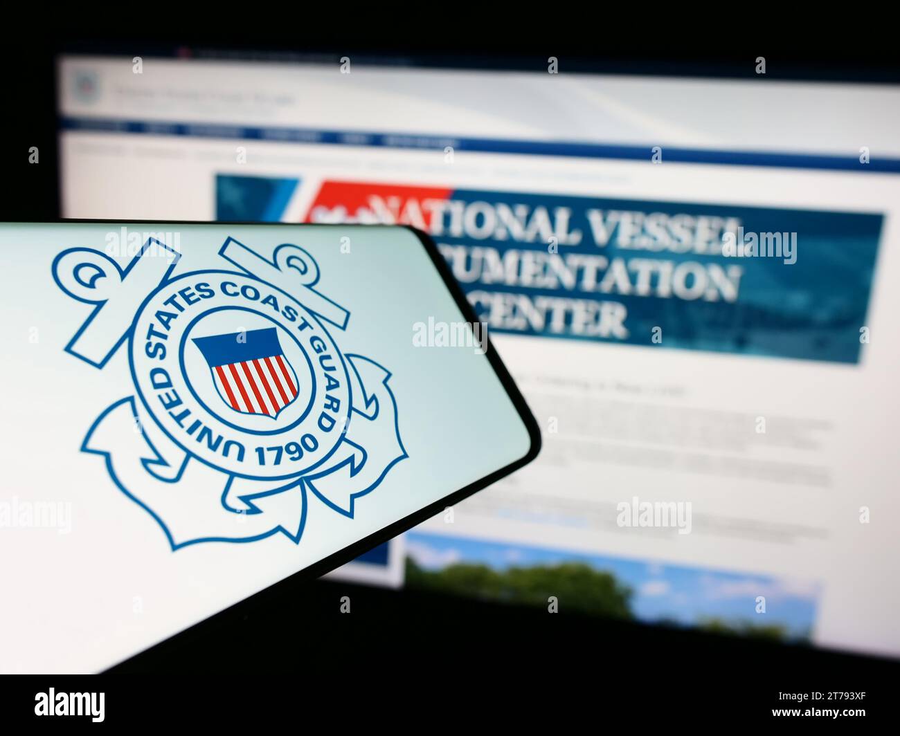 Smartphone with seal of United States Coast Guard (USCG) in front of website. Focus on center of phone display. Stock Photo