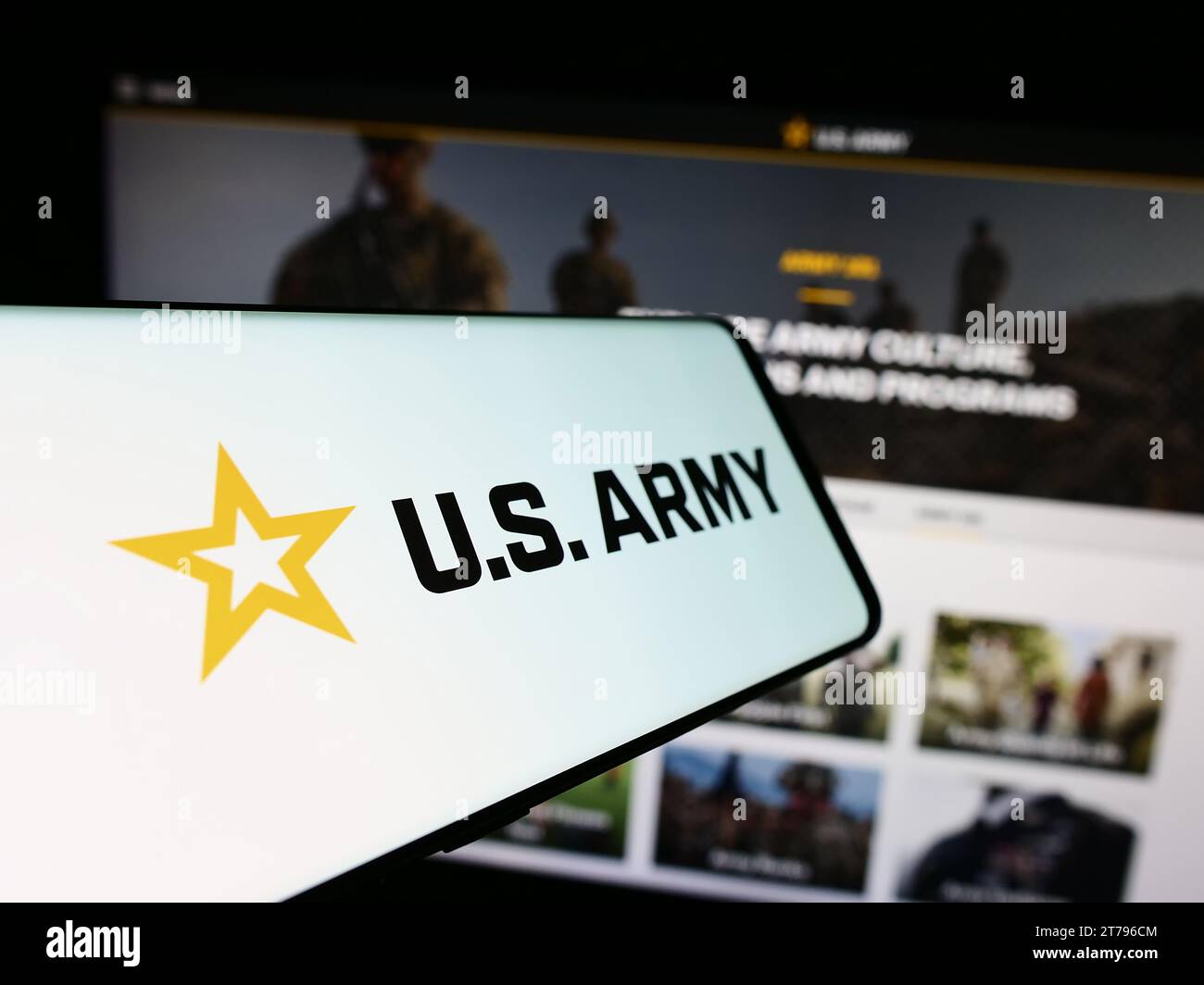 Smartphone with logo of United States Army in front of website. Focus on center-left of phone display. Stock Photo
