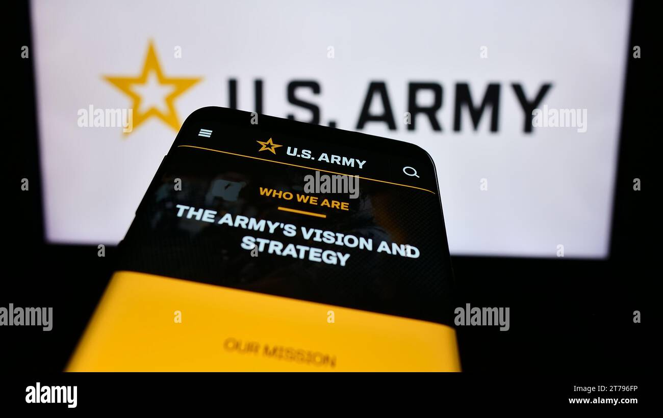 Mobile phone with website of United States Army in front of star logo. Focus on top-left of phone display. Stock Photo