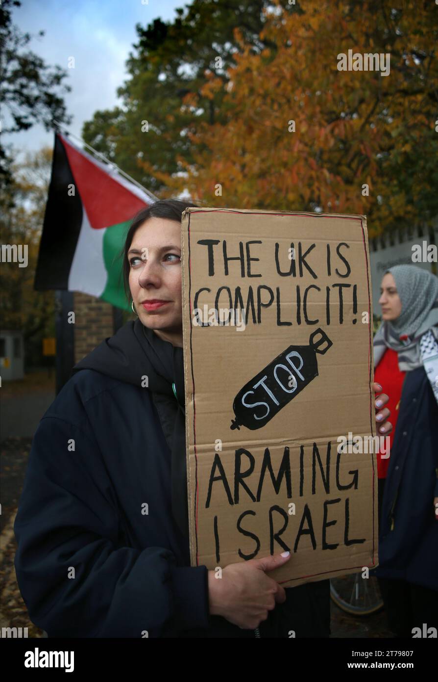 A supporter holds a sign saying ‘The UK is Complicit Stop Arming Israel' outside Snaresbrook Crown Court. Palestinian Actionists known as ‘The Elbit Eight' are facing conspiracy charges to commit criminal damage, burglary and some of them, blackmail, against Israeli arms company Elbit systems. The charges go back to 2020. Six weeks have been set aside at court. Palestine Action believe that Elbit's businesses in the UK manufacture drones that are being used in Gaza and elsewhere against the Palestinian people. Their direct actions against Elbit Systems in the UK have already seen two of their Stock Photo