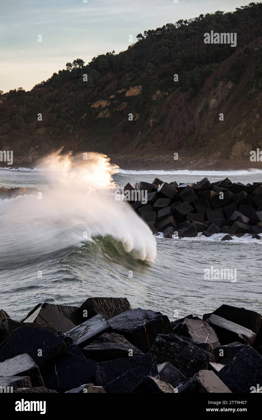 Wave breaking in the San Sebastian river mouth, Spain Stock Photo