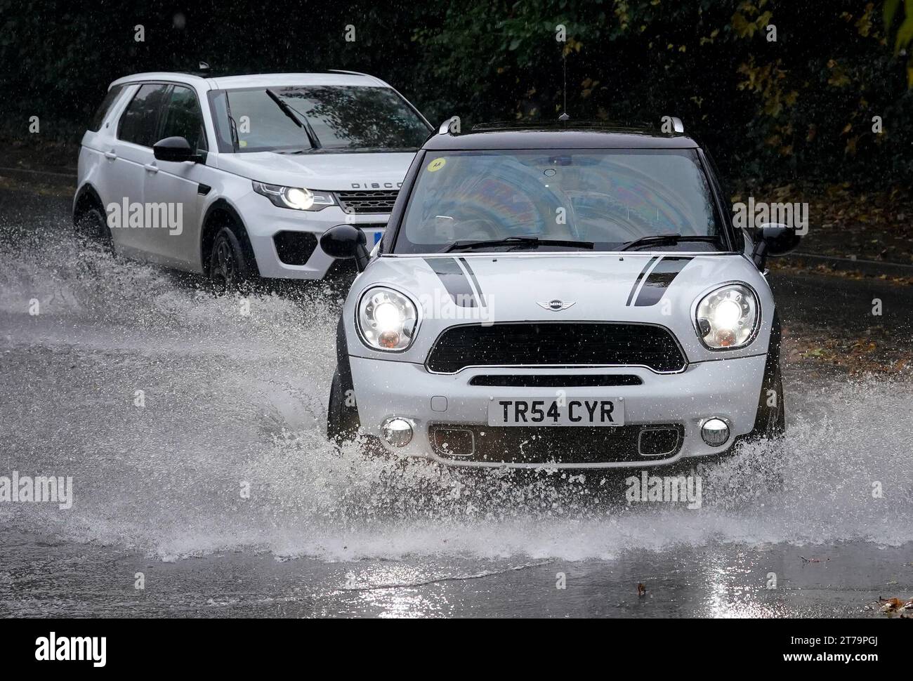 Cars pass through a flooded road in Ashford, Kent. A week's worth of