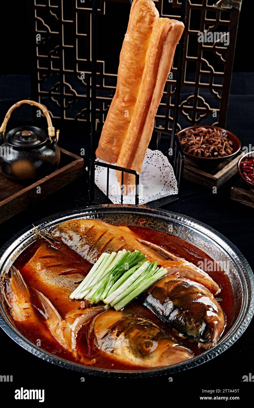Braised River Fish Head with Deep Fried Dough Stick Stock Photo