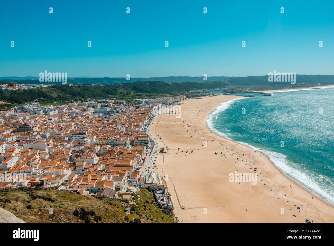 A coastal town with colorful terracotta rooftops and a tranquil azure ...