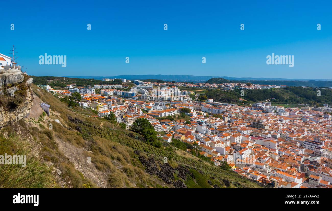 A coastal town with colorful terracotta rooftops and a tranquil azure ...