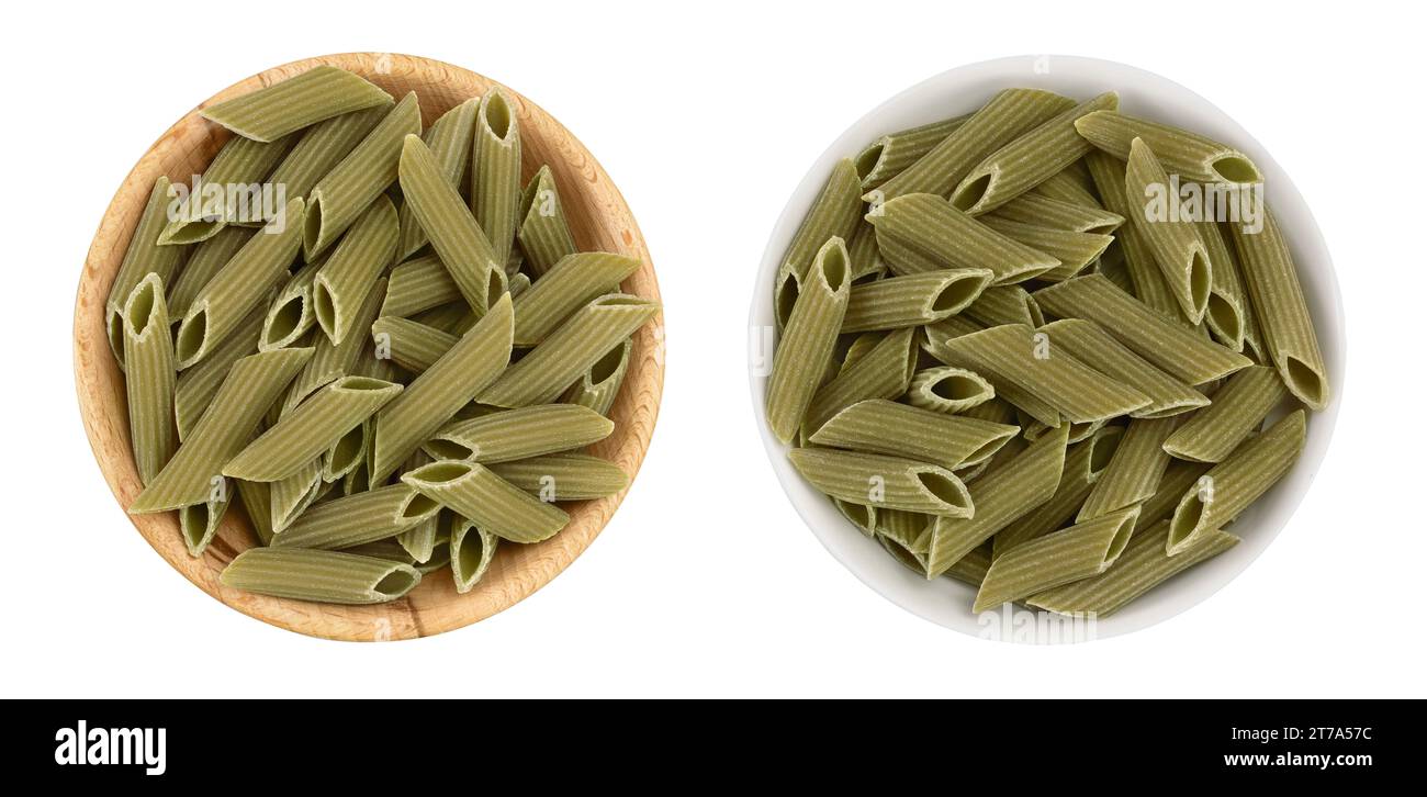Green pea penne pasta in wooden bowl isolated on white background . Organic food speciality. Gluten free. Top view. Flat lay Stock Photo