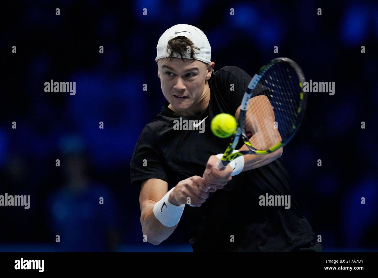 Denmark's Holger Rune returns the ball to Greece's Stefanos Tsitsipas ...