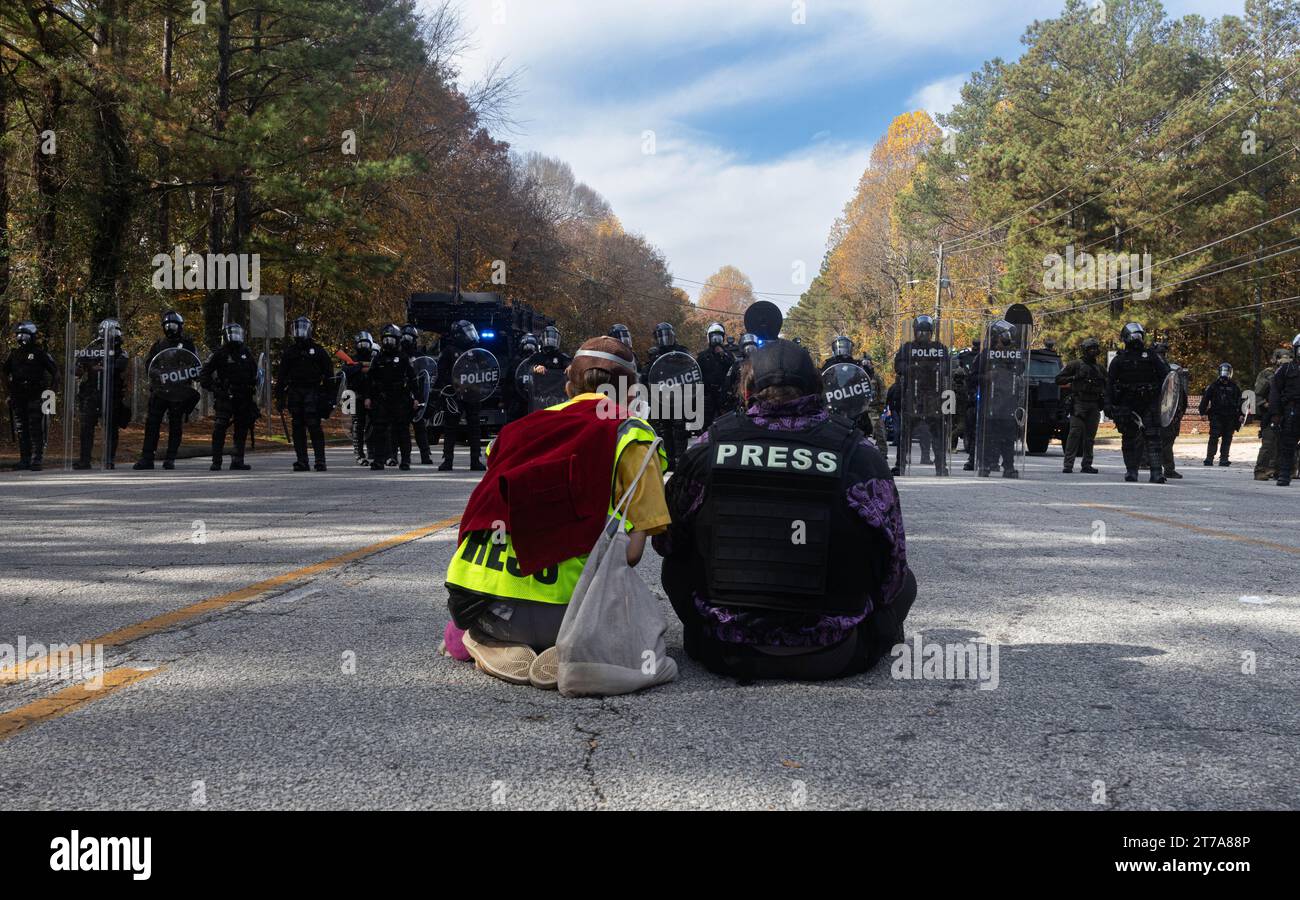 Two journalists film the Georgia law enforcement riot line after being tear gassed in Atlanta, Georgia on Monday, Nov. 13, 2023. ‘Stop Cop City’ activists gathered from across the United States to attend the ‘Block Cop City’ march to the construction site for the Atlanta Public Safety Training Center. (Photo by Carlos Berrios Polanco/Sipa USA) Stock Photo