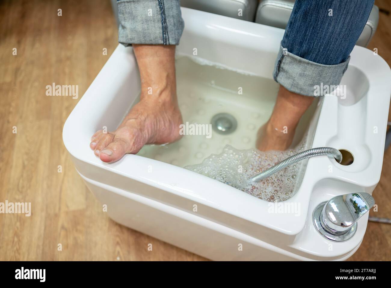 concept of male pedicure, foot pedicure, cosmetologist makes classic pedicure for an elderly male client. Stock Photo