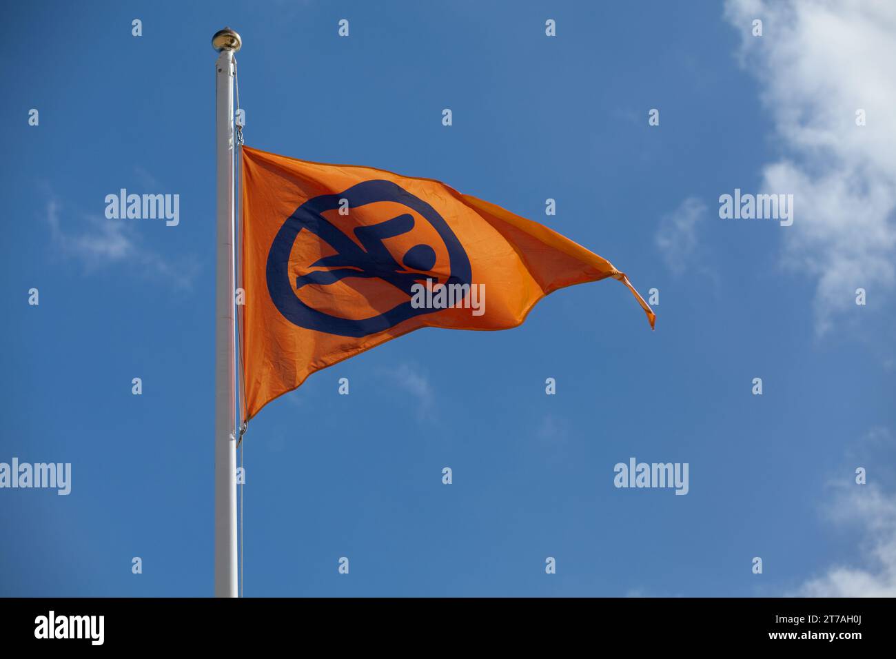 Orange flag indicating it is swimming is dangerous but lifeguards are