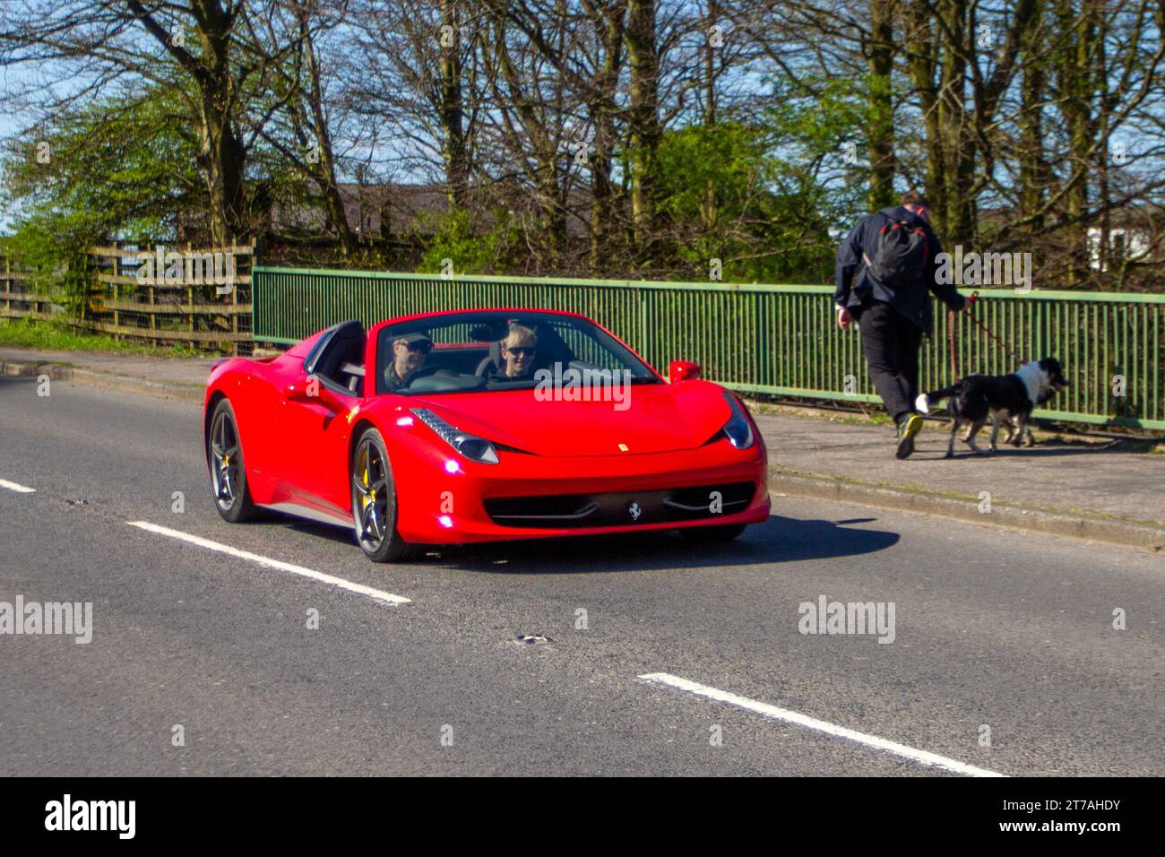 2014 red Ferrari 458 Spider Dct S-A sports car; Vehicular traffic, moving vehicles, cars, vehicle driving on UK roads, motors, motoring on the M6 motorway highway UK road network Stock Photo