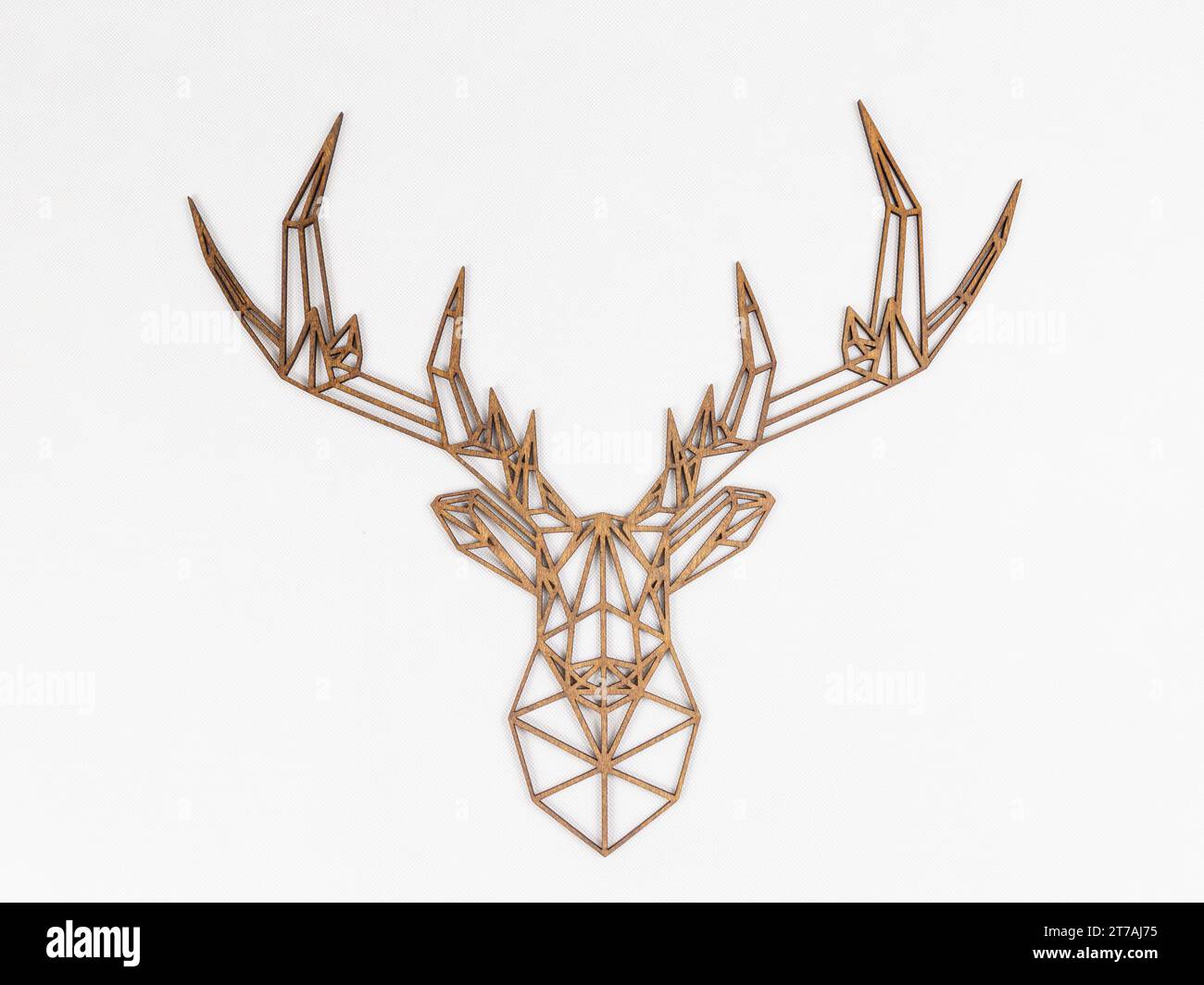 Geometric deer head sculpture made from Laser cut wood on a white background. Stock Photo