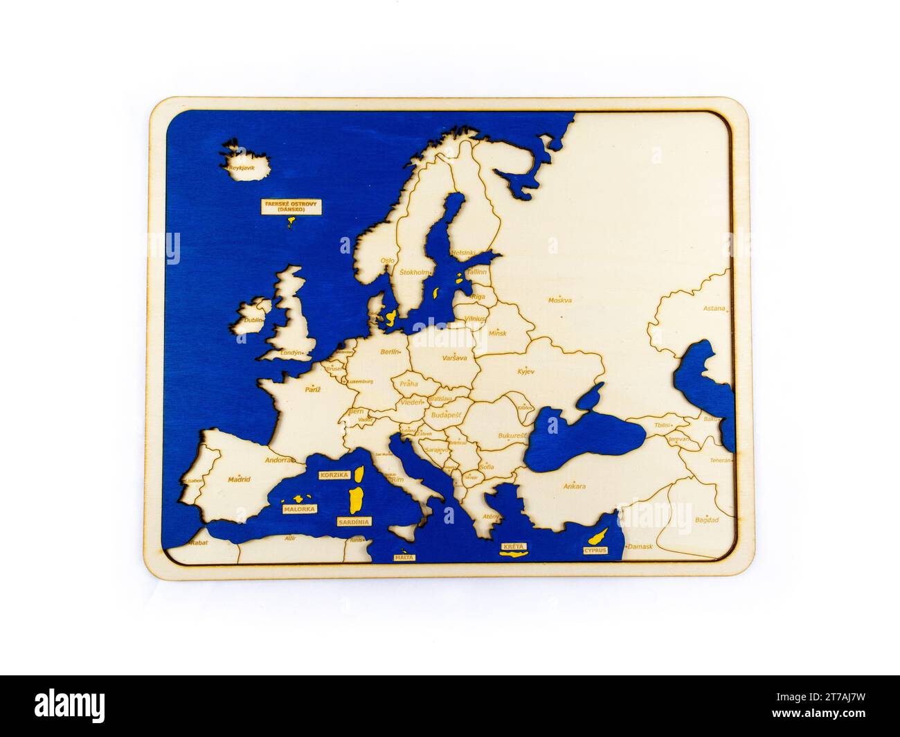 close-up photo of a wooden map of Europe with blue and yellow highlights. The map is made of wood and has been laser-cut to create a 3D relief effect. Stock Photo